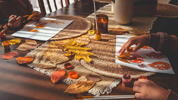 istock Autumn art project with children using leaves and paint 2241239437