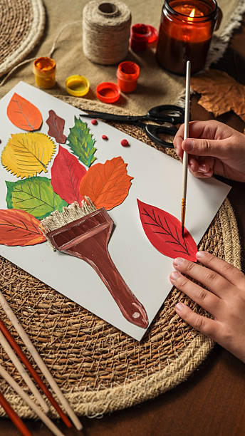 istock Autumn art project with colorful leaves and paint 2241239446