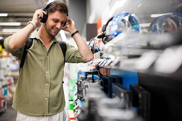 istock Man testing headphones in electronic store 2241239856