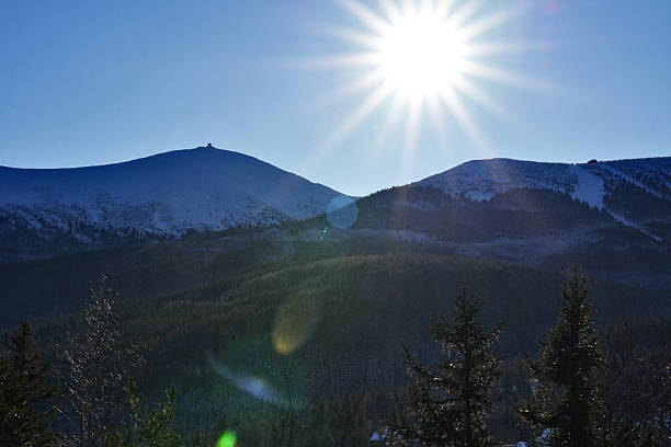 istock Afternoon sun over winter mountains and forest. 2241239996