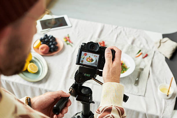 istock Man Photographing Food with Digital Camera Indoors 2241242169