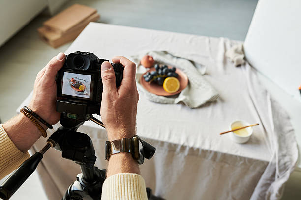 istock Man Photographing Food Arrangement Using Digital Camera 2241242717