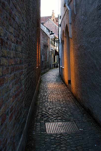 istock Historic European Alley with Warm Brick Architecture 2241243438
