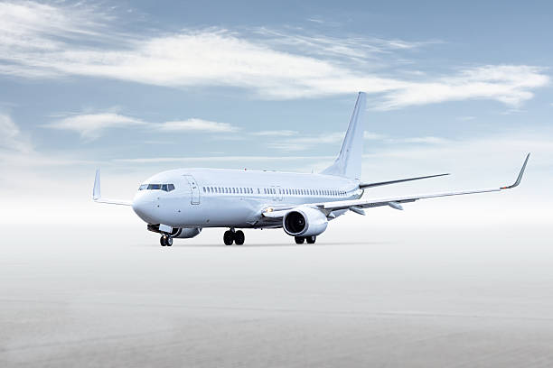 istock White passenger aircraft isolated on bright background with sky 2241245393