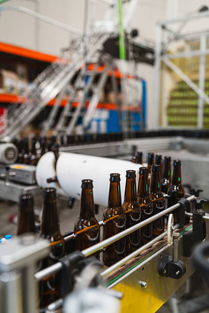 istock Empty beer bottles moving along production line in brewery 2241246584