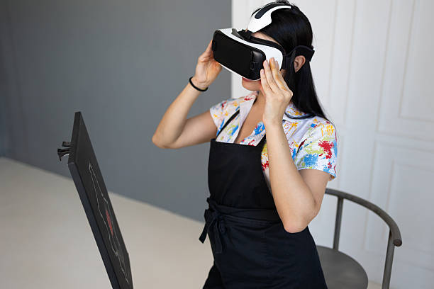 Creative artist painting with VR headset and brush at easel