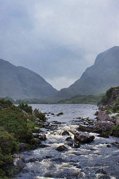 istock Misty mountain stream cascading through rugged landscape 2241252513
