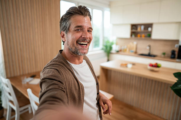istock Happy adult man taking a selfie in modern kitchen 2241253613