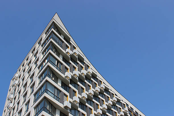 istock Original design of a multi storey residential house with a sharp upward curved corner 2241254605