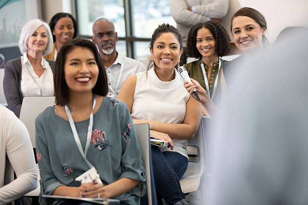istock Diverse group of people actively participating in a discussion during an indoor event. 2241257291