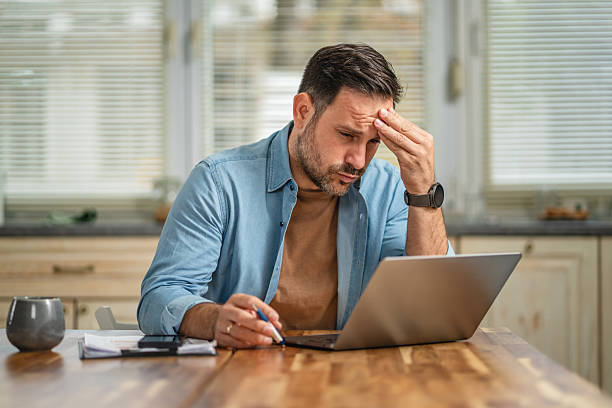 istock Man experiencing stress and burnout working from home 2241260822