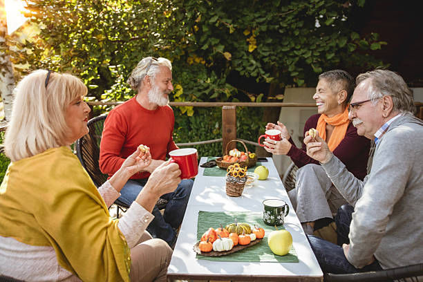 istock Older friends hanging out on the terrace 2241261607
