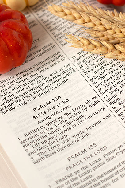 istock Bless the LORD psalm text in open holy bible book with pumpkin fruit and wheat 2241261642