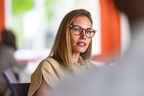 istock Professional Woman With Glasses Speaking In Modern Office During Work Conversation 2241263623
