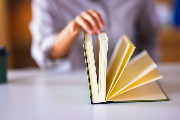 istock Open Book With Fanned Pages On Desk, Focused Reading Moment For Study and Learning 2241263809