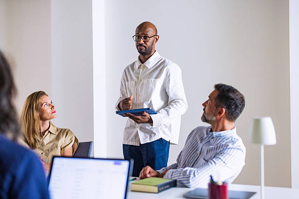istock Professional Office Meeting With Presenter And Colleagues In Modern Workspace 2241263889