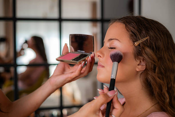 istock Makeup artist applying blush to young woman's cheek 2241264631