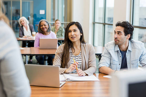 istock Diverse group of adults attentively participating in a learning or training session indoors. 2241269717