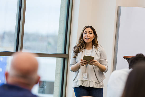 istock Woman presents information to colleagues using a digital tablet in an office setting. 2241269771