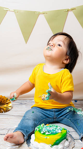 istock Baby celebrating first birthday during messy cake smash 2241270600