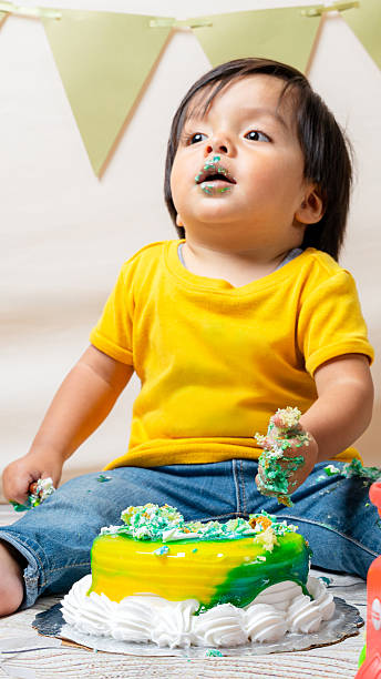 istock Baby boy enjoying first birthday cake smash celebration 2241270678