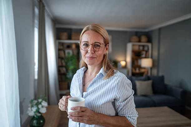 istock Mature woman drinking coffee at home 2241270781