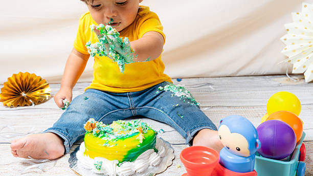 istock Baby enjoying a messy first birthday cake smash celebration 2241270808