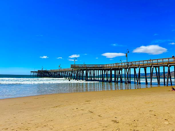 Pismo Beach, California, USA - March 2, 2023.  Pismo Beach pier, and wooden boardwalk in the heart of Pismo Beach city, California