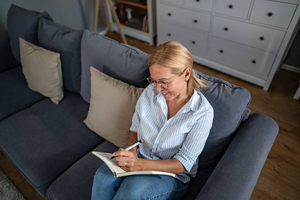 istock Woman writing in journal during relaxing day at home 2241272814