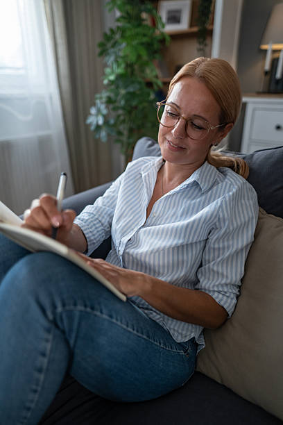 istock Woman writing in journal during relaxing day at home 2241272842