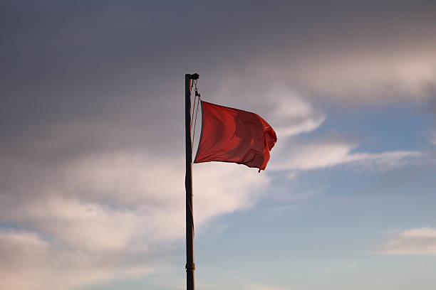 istock Red flag is flying in the sky 2241274782