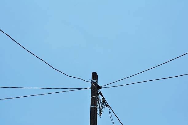 Utility Pole with Electric Wires against Clear Blue Sky