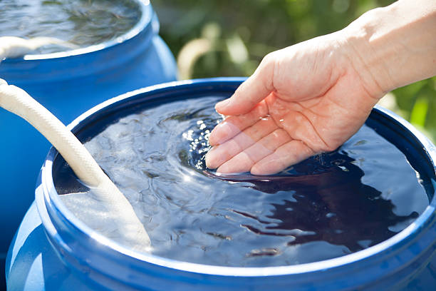 istock Hand Touching Rainwater Collected in a Storage Tank 2241285215