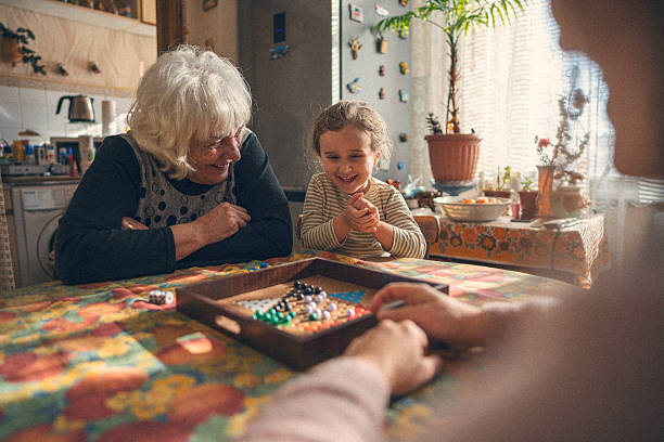 istock Family Connection. Multigenerational Family Plays Board Game 2241285950