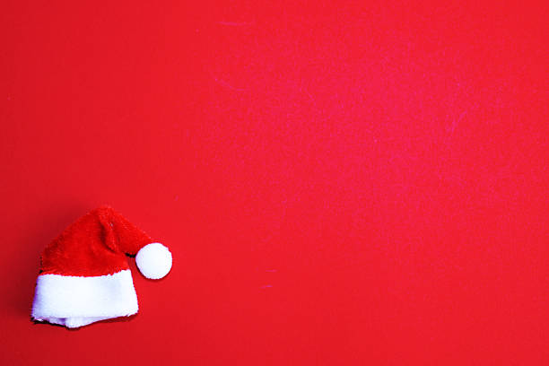 istock Santa Claus hat on red background 2241286451