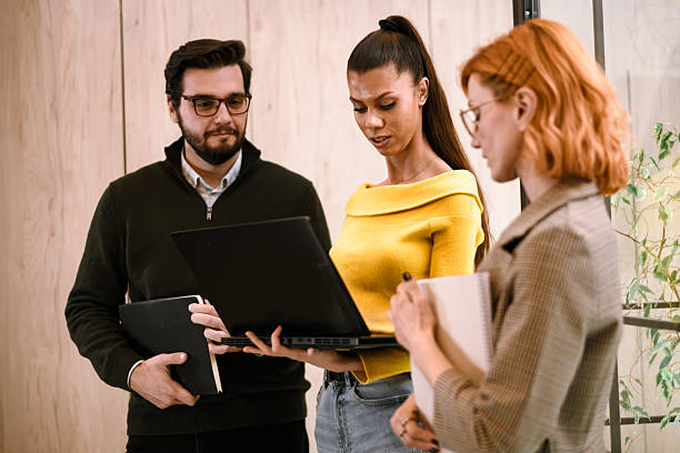 istock Group of young professionals discussing projects during a meeting in a modern office space in the afternoon 2241286622