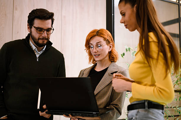 istock Team members collaborating on a project during a creative meeting in a modern office space with large windows and green plants 2241286693