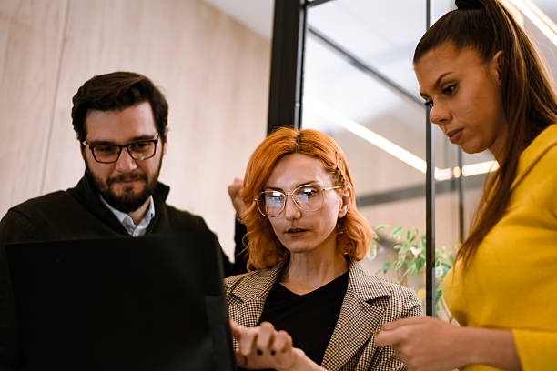 istock Colleagues collaborating on a project in a modern office setting during the day 2241286750