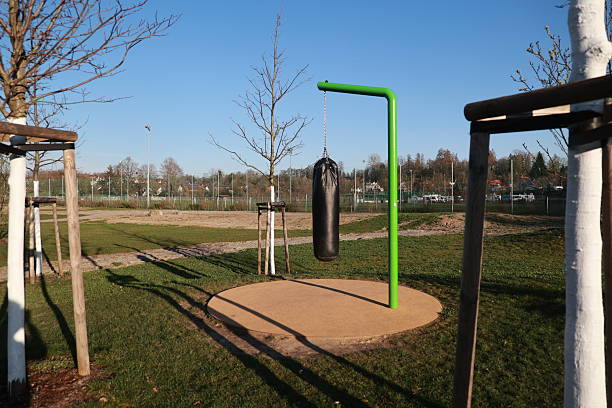 istock A green and black punching bag hangs from a green pole in a park 2241286937
