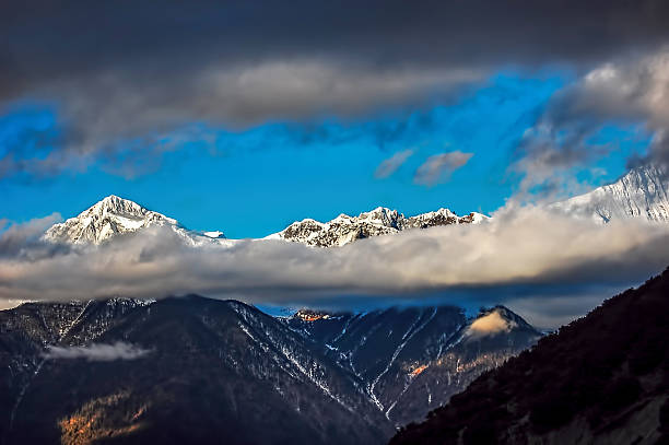 istock Majestic Snow-covered Mountains with Clouds in the Sky 2241288289