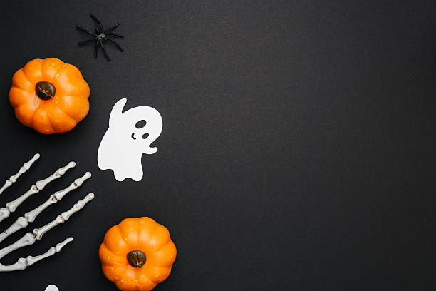 istock Pumpkin ghost and spider decoration on a black background, creepy Halloween celebration 2241293049