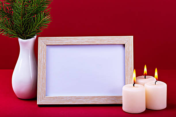 istock Elegant mock up with empty frame, candles and decorative plant on vibrant red background 2241294183