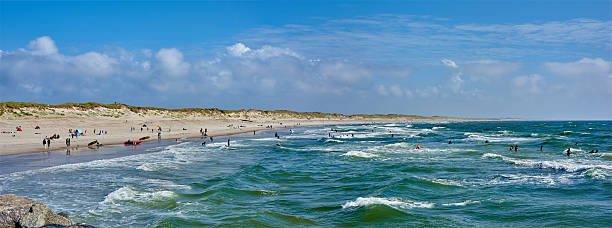 istock Welcoming Sandy Beach Scene with Waves and People Exploring Nature 2241294409