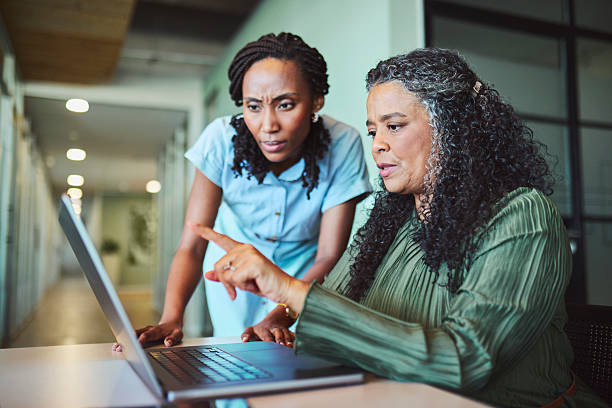 istock Two Concerned Black Businesswomen Intensely Analyzing Data on Laptop 2241294438