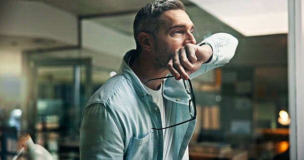 istock Man, thinking and stress at window, office or reflection for mistake, decision or issue at company. Mature person, glasses and insight with problem solving for crisis, anxiety or solution at agency 2241294513