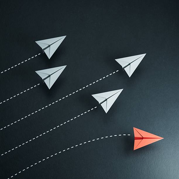 istock Red paper origami plane have individual direction from unique white planes in different way. Business strategy and opportunity concept.3D rendering on black background. 2241294870