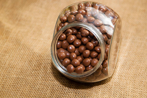 istock Glass jar filled with milk chocolate candies 2241300646