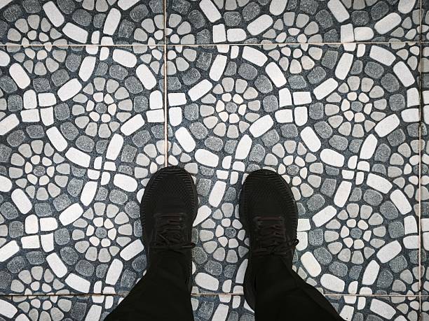 istock A person's feet standing wearing black shoes 2241301726