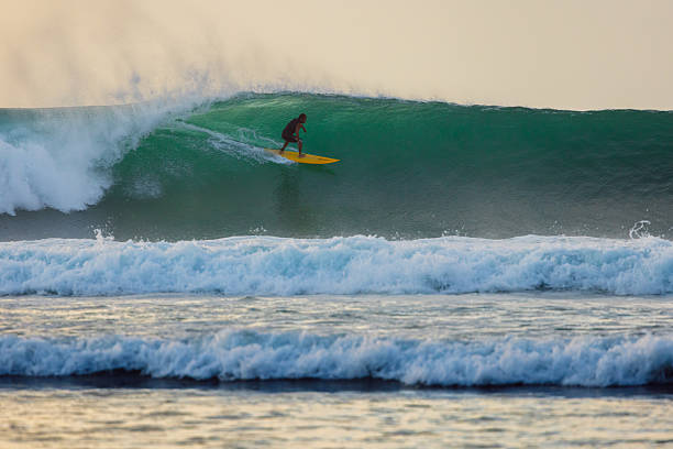 Bali, 2018. Surfer riding a wave in bali