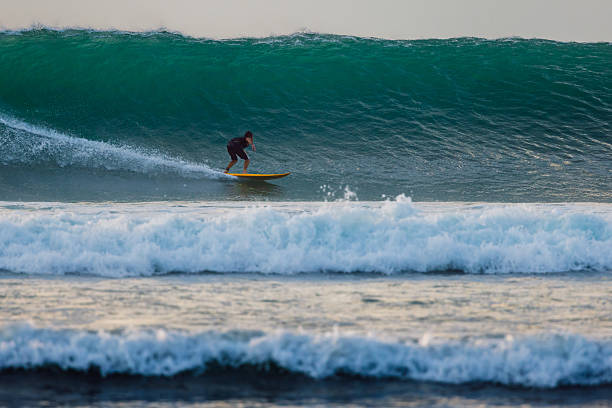 Deal, New Jersey - August 10, 2024: surfers surf the remnants of Hurricane Debby in the waters off Deal